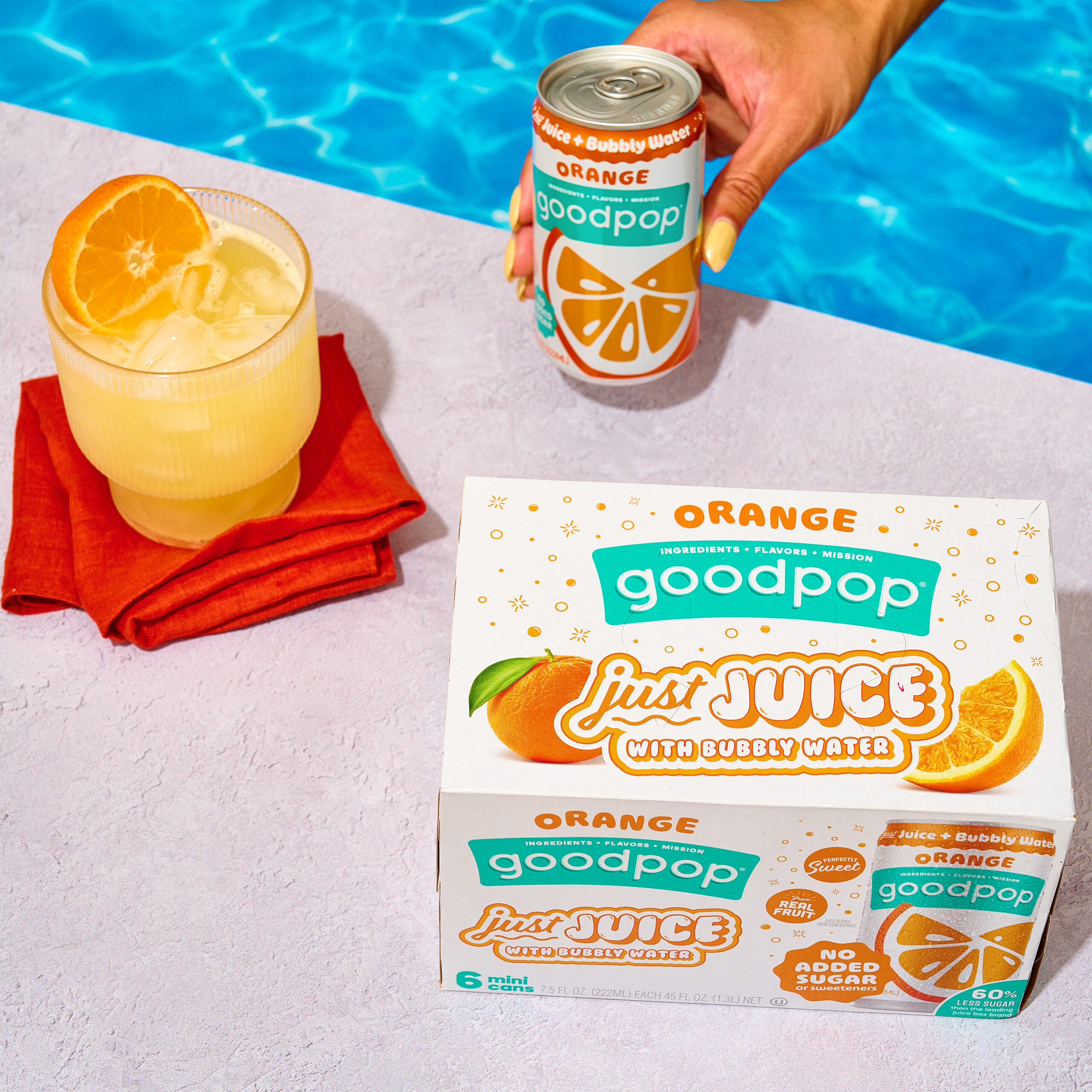 Woman enjoys GoodPop Orange Mini Cans pool side