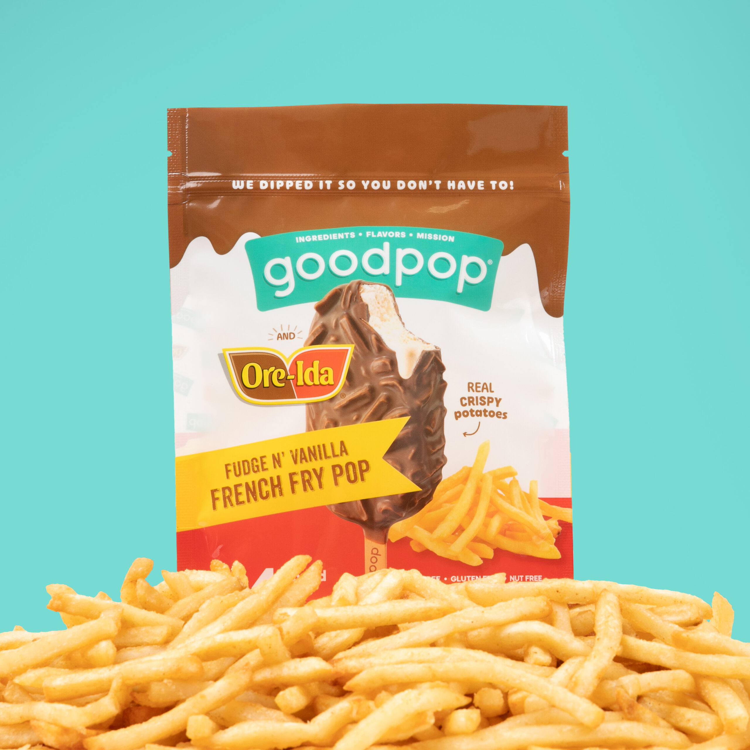 GoodPop x Ore-Ida Fudge n' Vanilla French Fry Pop bag sits atop a pile of crispy french fries