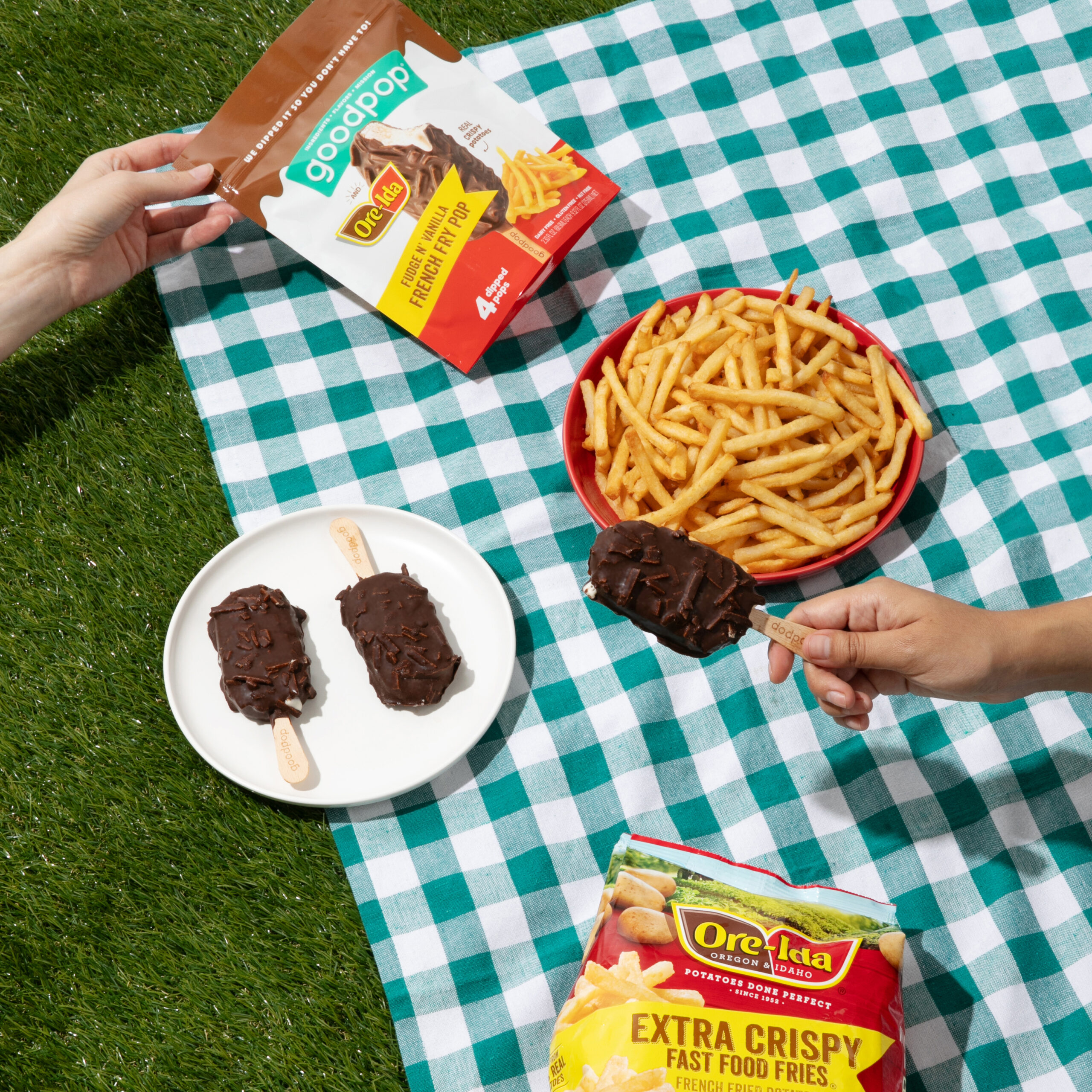 Friends enjoy the sweet and salty combo of GoodPop x Ore-Ida Fudge n' Vanilla French Fry Pops at a picnic