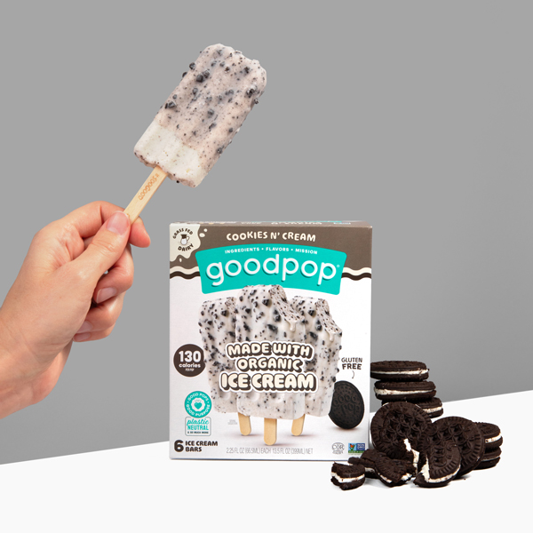 Woman holds GoodPop Cookies n' Cream ice cream bar