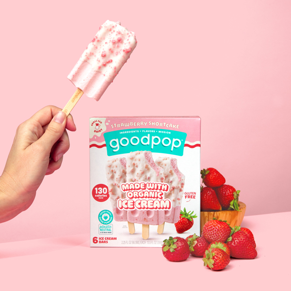 GoodPop Strawberry Shortcake ice cream bars sit next to pile of fresh strawberries