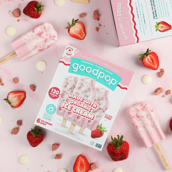 GoodPop Strawberry Shortcake ice cream bars displayed with fresh strawberries on pink countertop