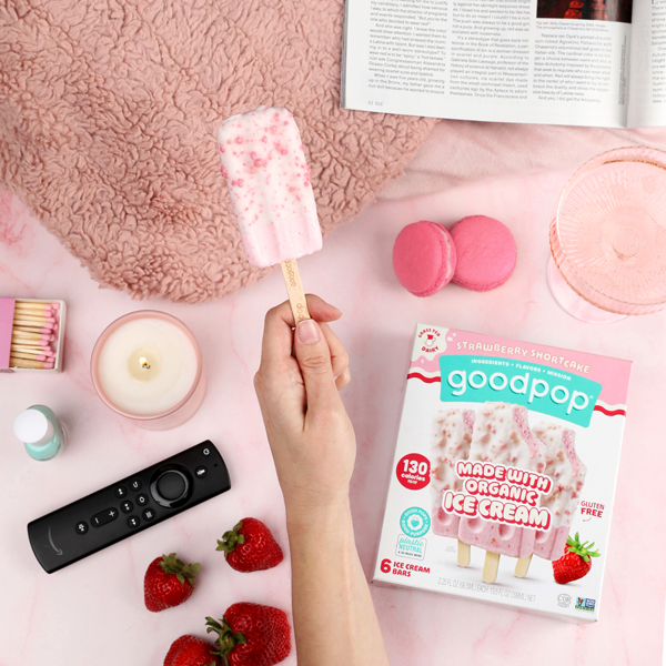 Woman enjoys a cozy night in with GoodPop Strawberry Shortcake ice cream bars