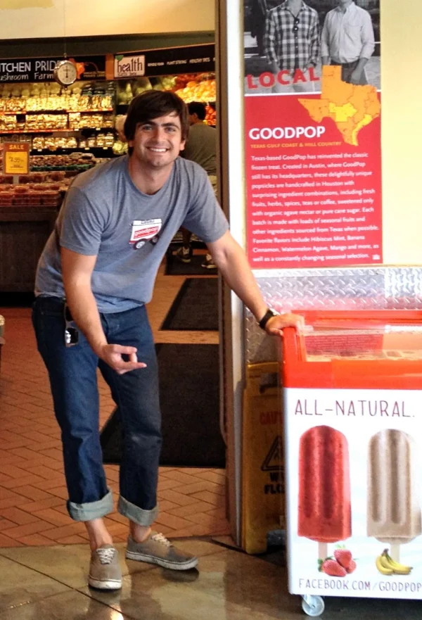 Daniel Goetz standing aside popsicle freezer in Whole Foods.